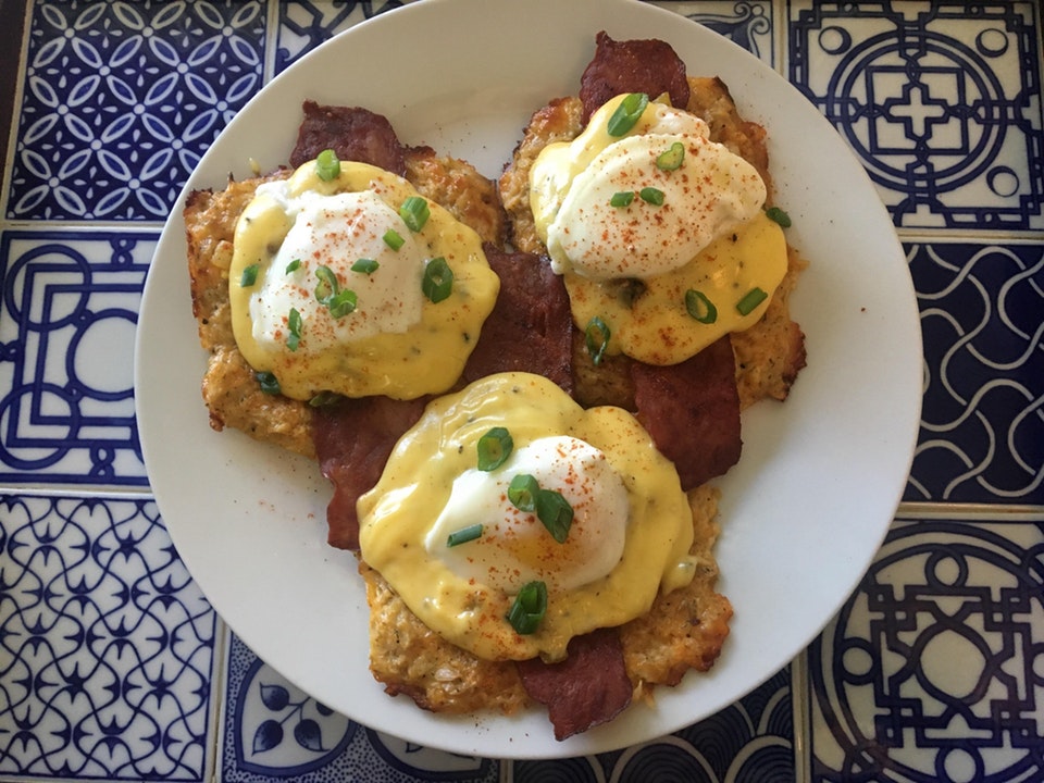 Eggs Benedict with homemade hollandaise sauce, bacon, and cheddar cauliflower hash browns
